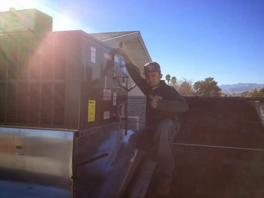HVAC technician performing AC Tune-Up on a rooftop unit in East Fishkill
